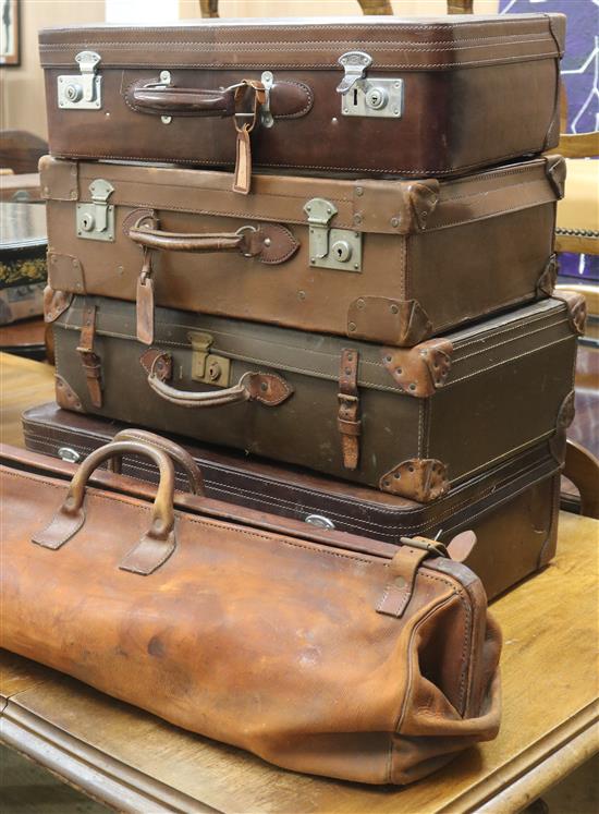 A group of four leather suitcases and a leather bag